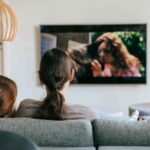 two people watching tv